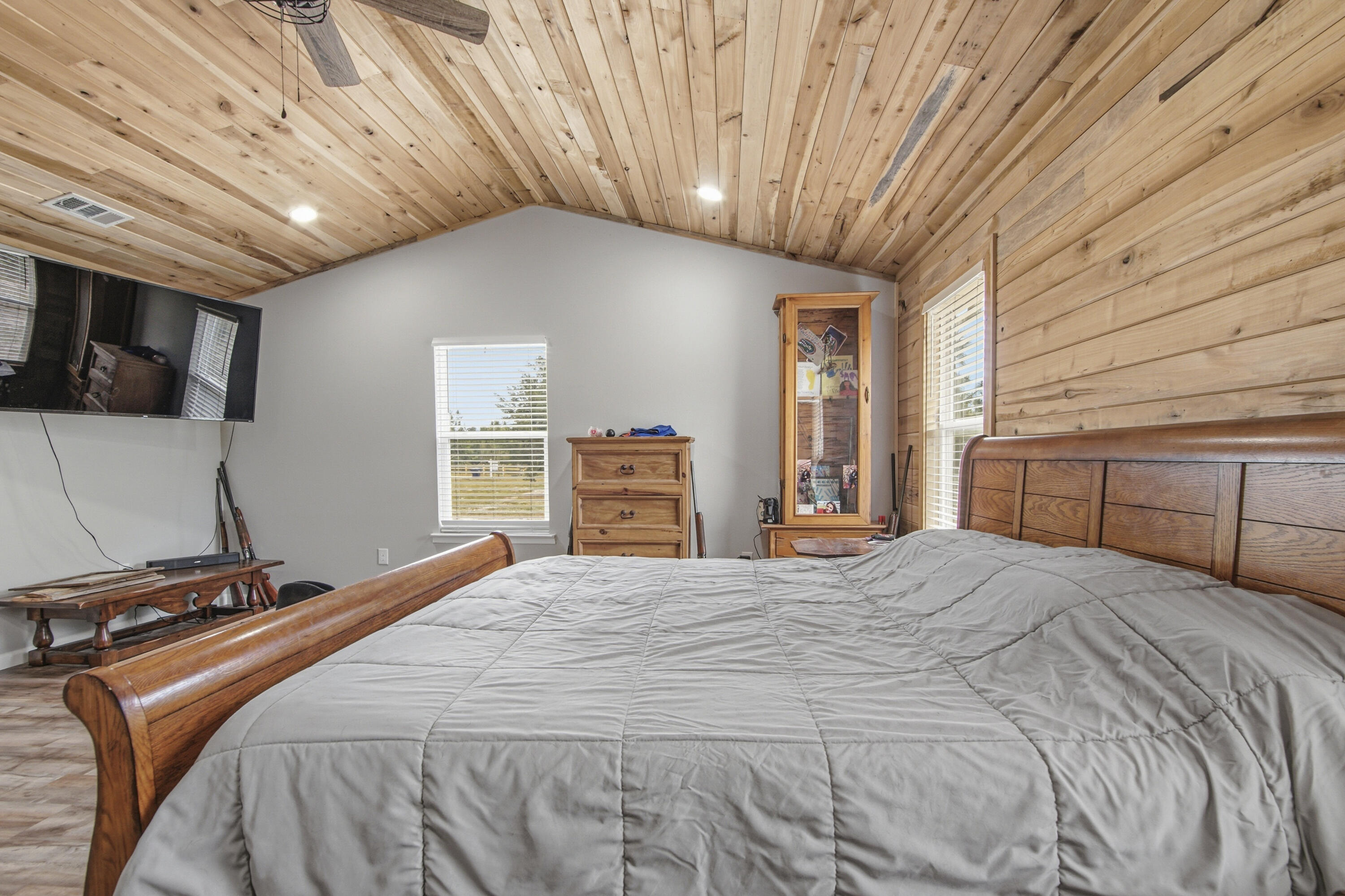 7514 Laird Road Florala, AL 36442 - Photo 16 of 48 a bedroom with a bed a dresser and flat screen tv