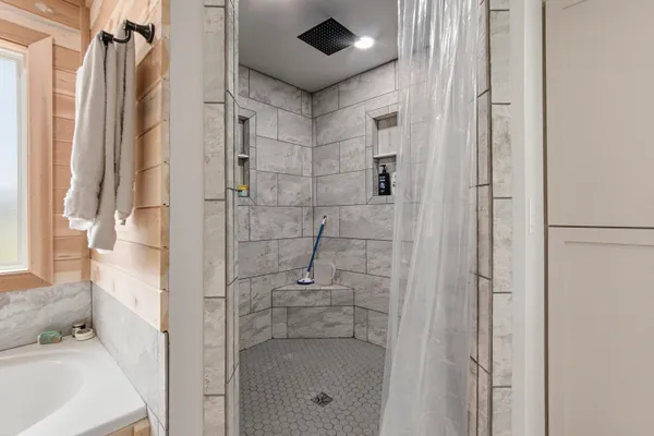 a bathroom with a shower and a sink