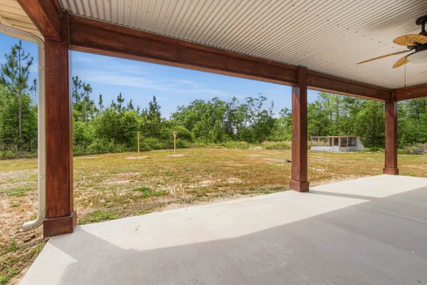 a view of a room with floor to ceiling windows and a big yard