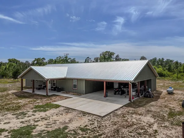 a view of a house with wooden floor and a yard