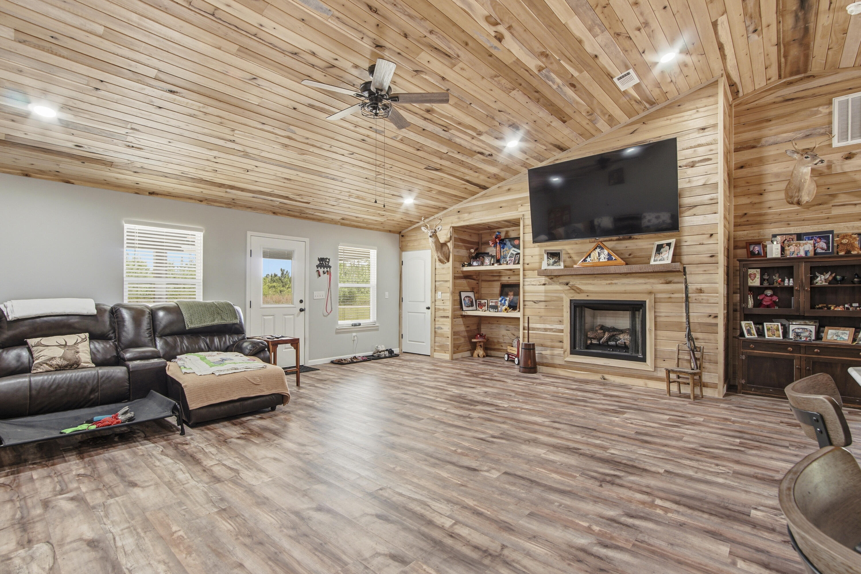 7514 Laird Road Florala, AL 36442 - Photo 5 of 48 a living room with furniture a fireplace a flat screen tv and a fireplace