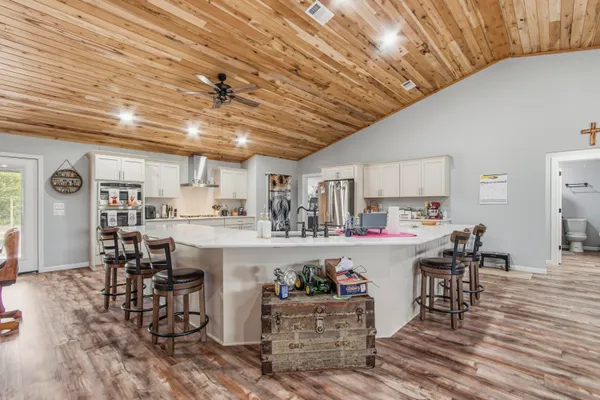 a kitchen with cabinets and wooden floor