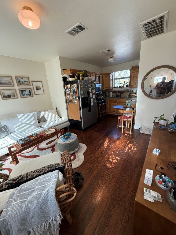 1313 Delano Street Austin, TX 78721 - Photo 14 of 32 Living room with dark wood finished floors
