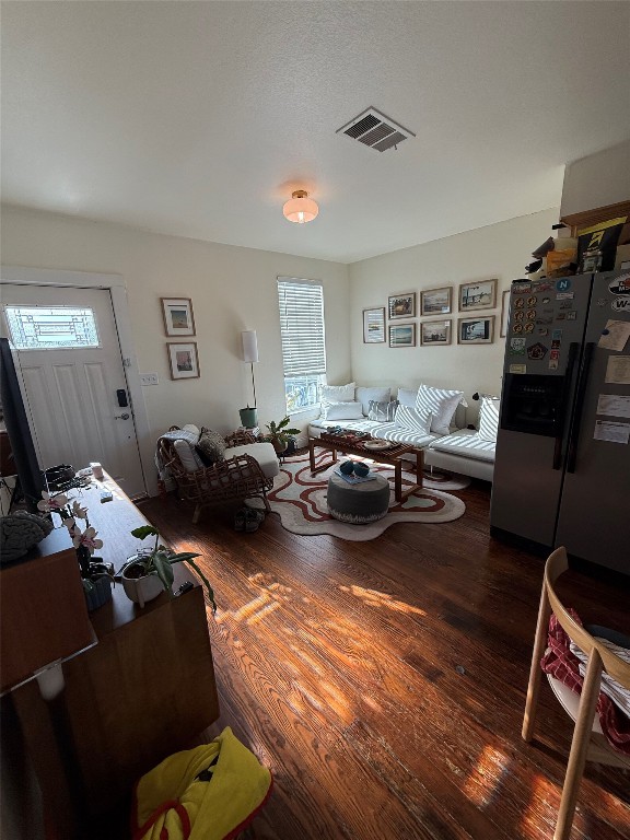 1313 Delano Street Austin, TX 78721 - Photo 15 of 32 Living area featuring wood-type flooring and plenty of natural light