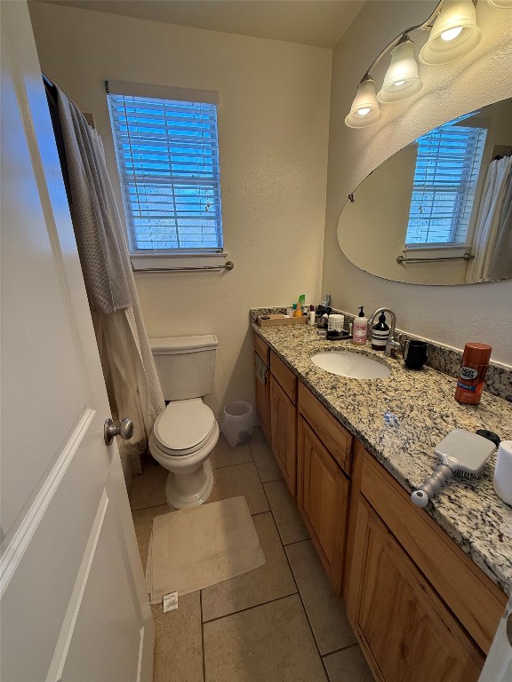 1313 Delano Street Austin, TX 78721 - Photo 17 of 32 Bathroom with curtained shower, vanity, and healthy amount of natural light