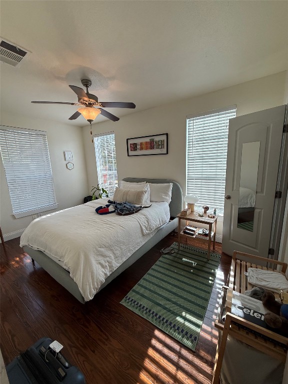 1313 Delano Street Austin, TX 78721 - Photo 19 of 32 Bedroom with a ceiling fan and dark wood finished floors