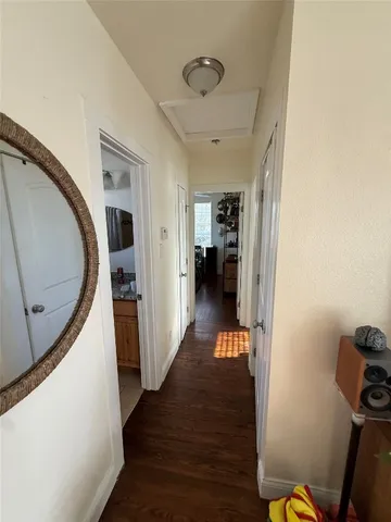 a bedroom with a bed next to a window with a flat screen tv