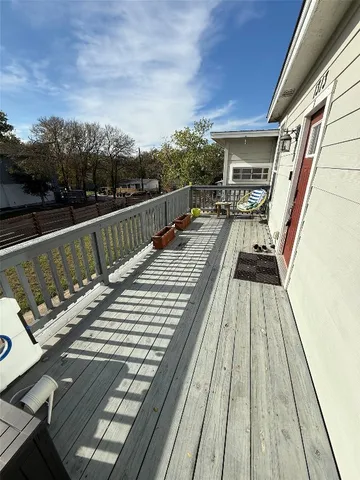 a view of hallway with furniture and wooden floor
