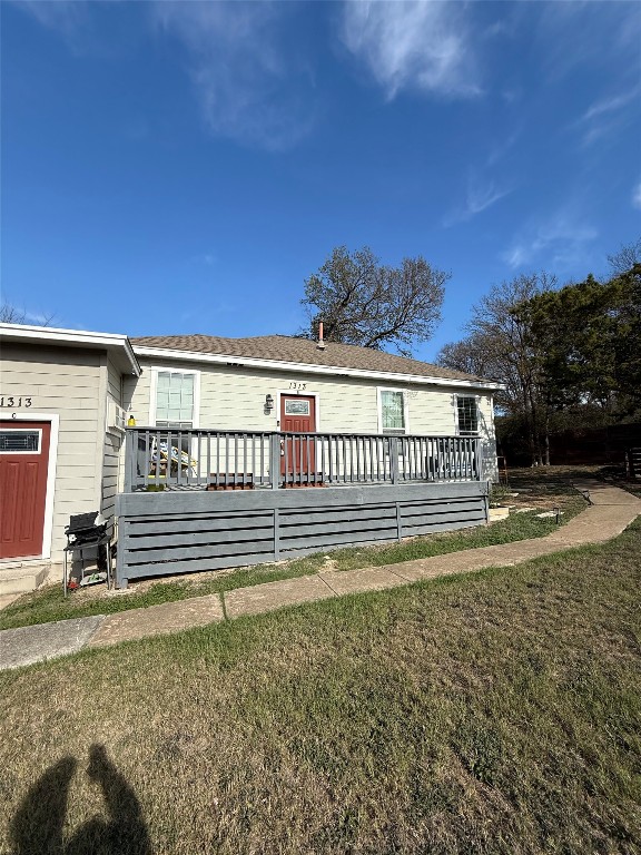 1313 Delano Street Austin, TX 78721 - Photo 28 of 32 Bungalow with a wooden deck and a front lawn