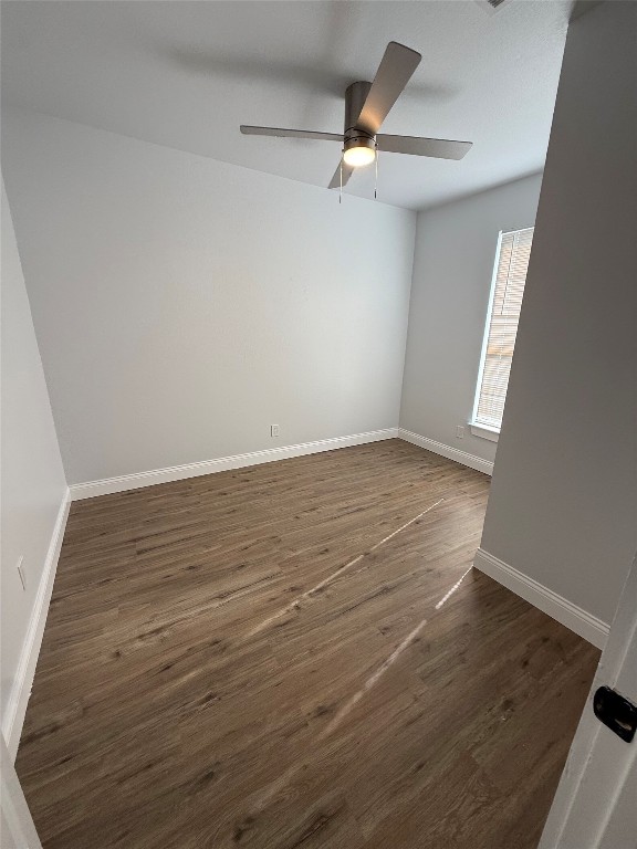 1313 Delano Street Austin, TX 78721 - Photo 5 of 32 Spare room featuring dark wood-style floors and baseboards