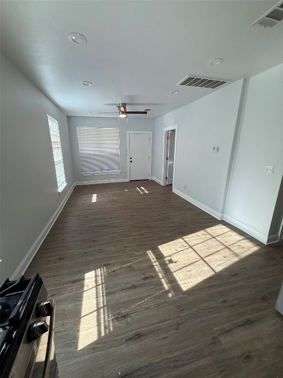 1313 Delano Street Austin, TX 78721 - Photo 7 of 32 Unfurnished living room with dark wood-style floors, a ceiling fan, and recessed lighting