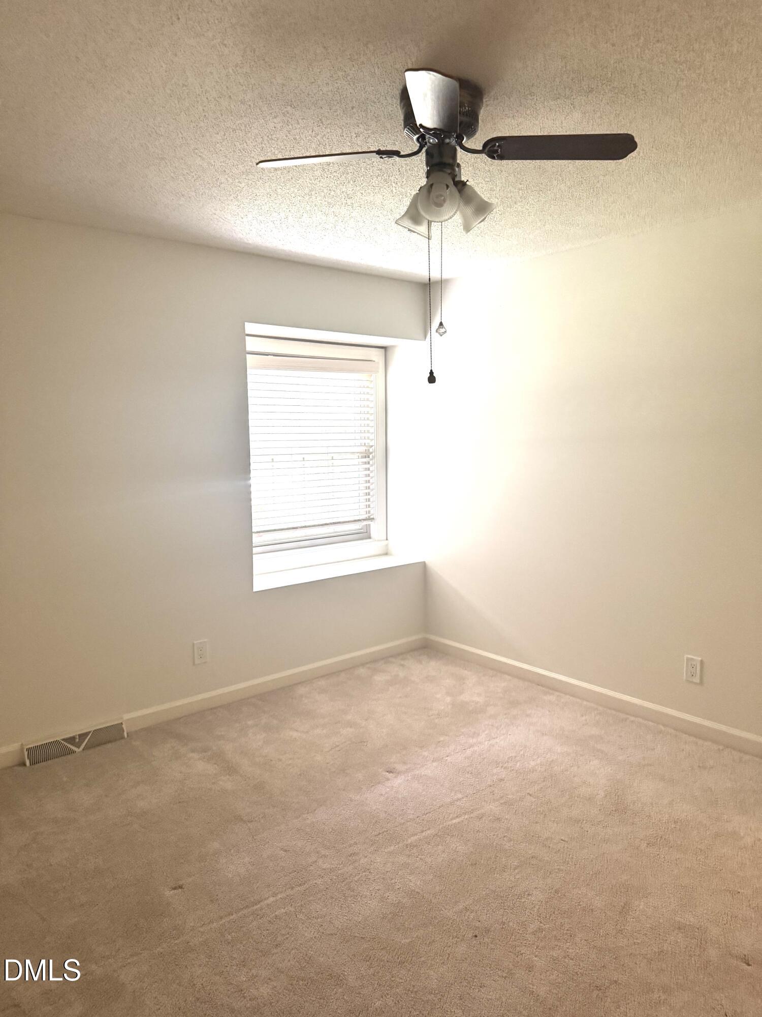 8133 Holly Forest Road Wake Forest, NC 27587 - Photo 38 of 50 an empty room with a window and a fan