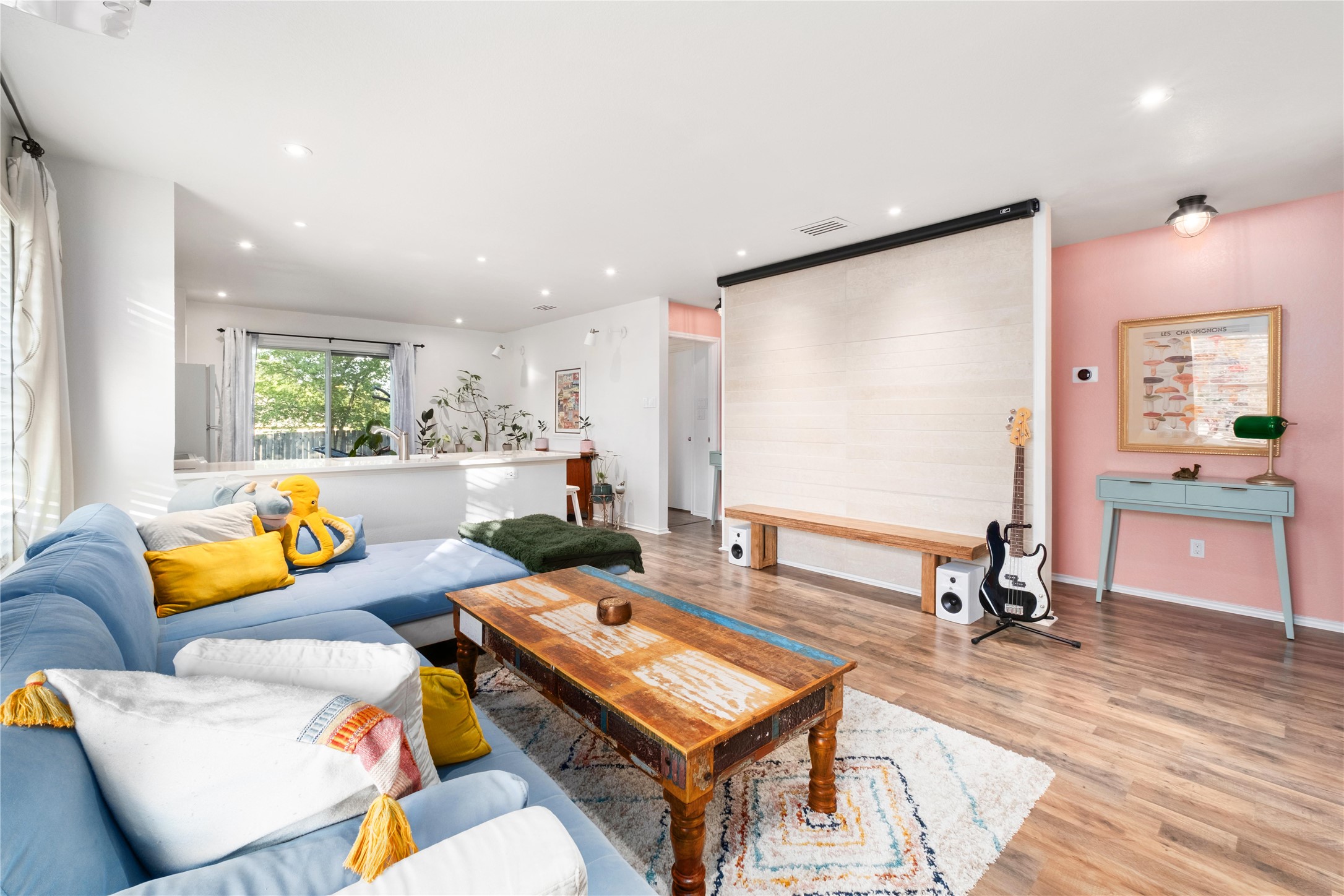 a room with furniture pool table wooden floor and windows