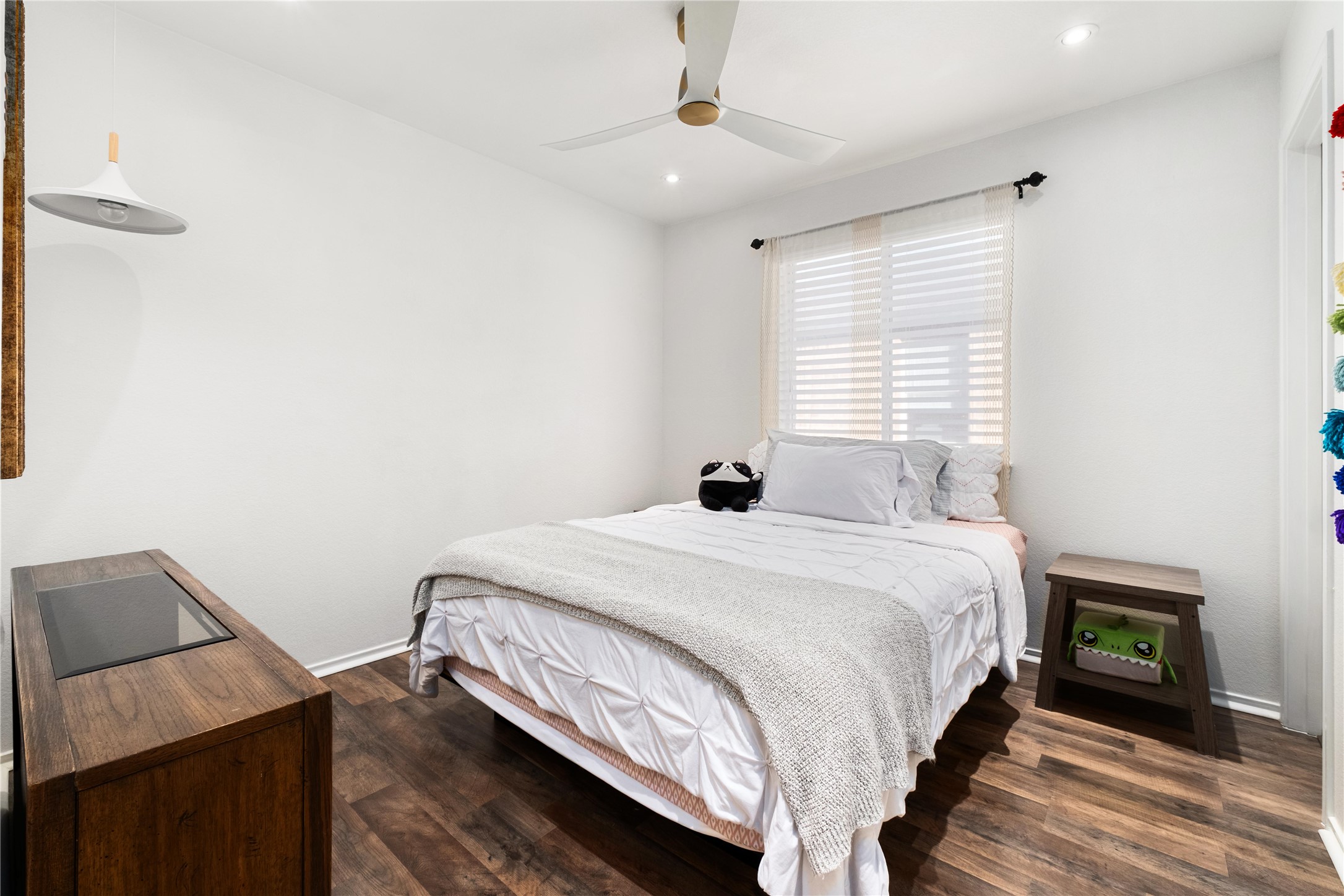 102 Woodley Road Leander, TX 78641 - Photo 13 of 24 a bedroom with a bed and a night stand