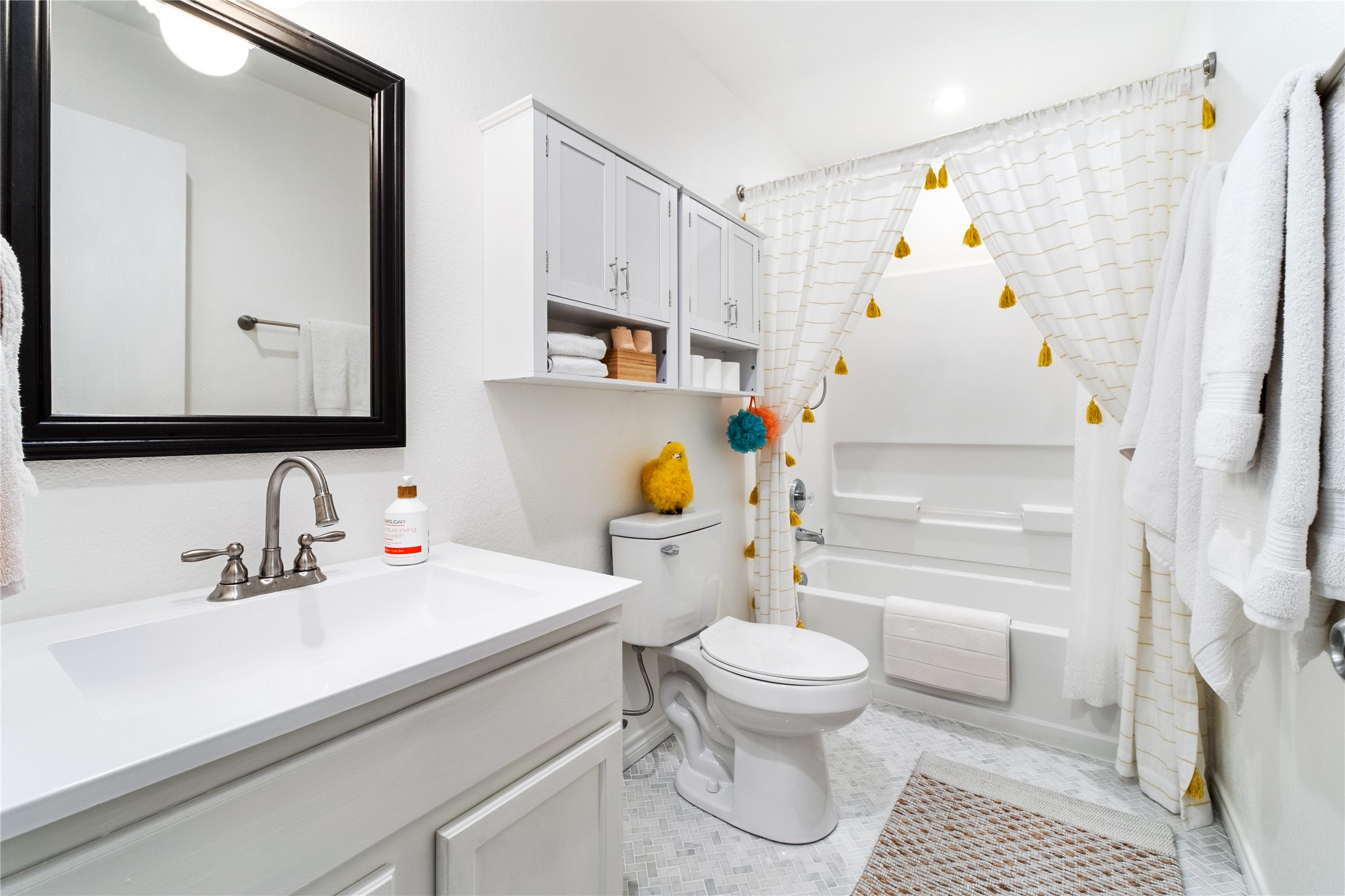 102 Woodley Road Leander, TX 78641 - Photo 14 of 24 a bathroom with a sink toilet and shower