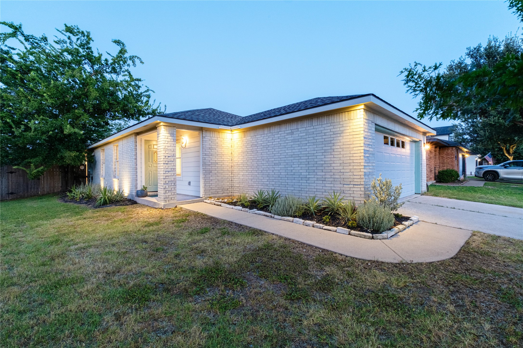 102 Woodley Road Leander, TX 78641 - Photo 22 of 24 a front view of a house with a yard and garage