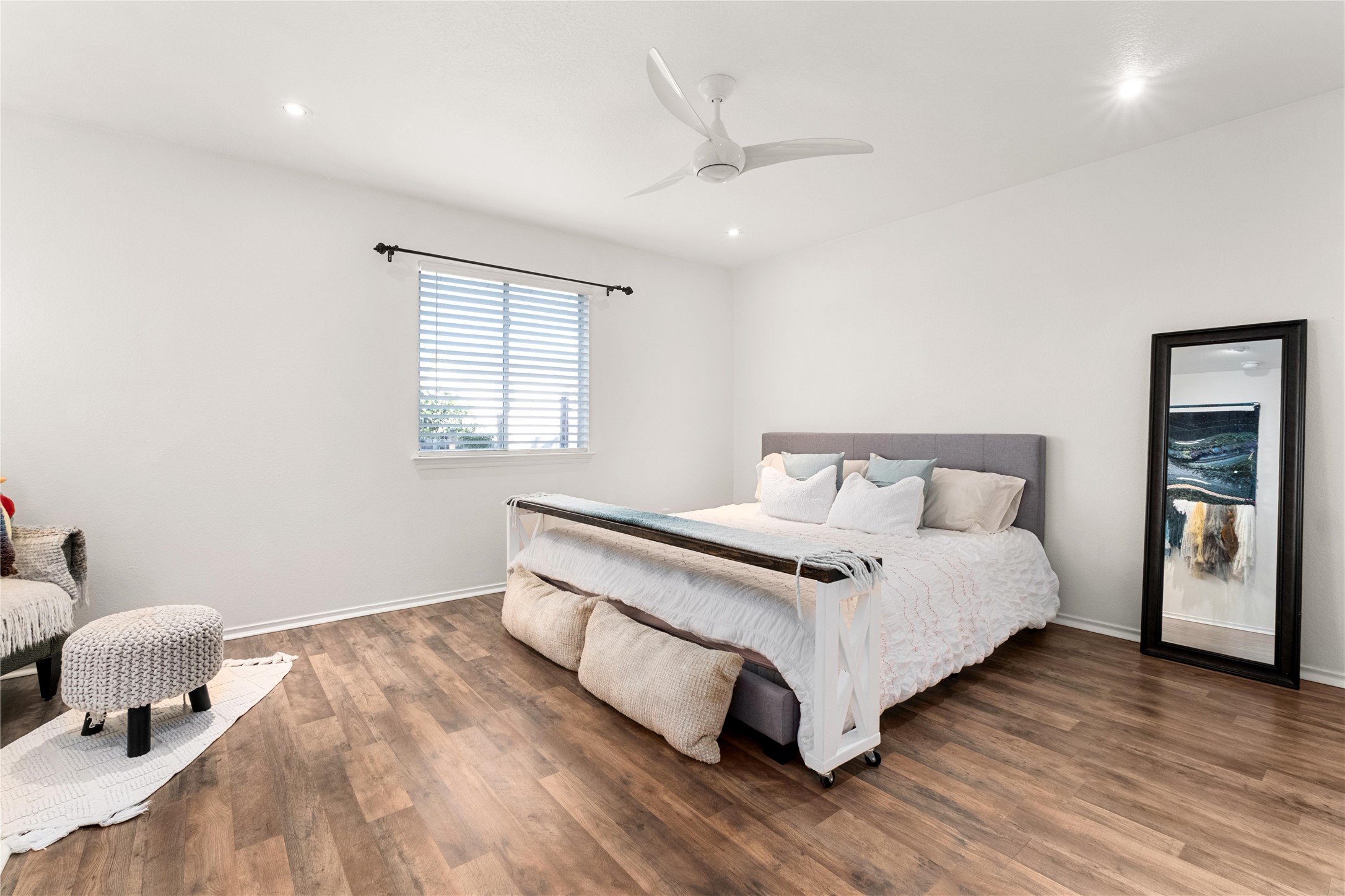 102 Woodley Road Leander, TX 78641 - Photo 8 of 24 a bedroom with a bed and wooden floor