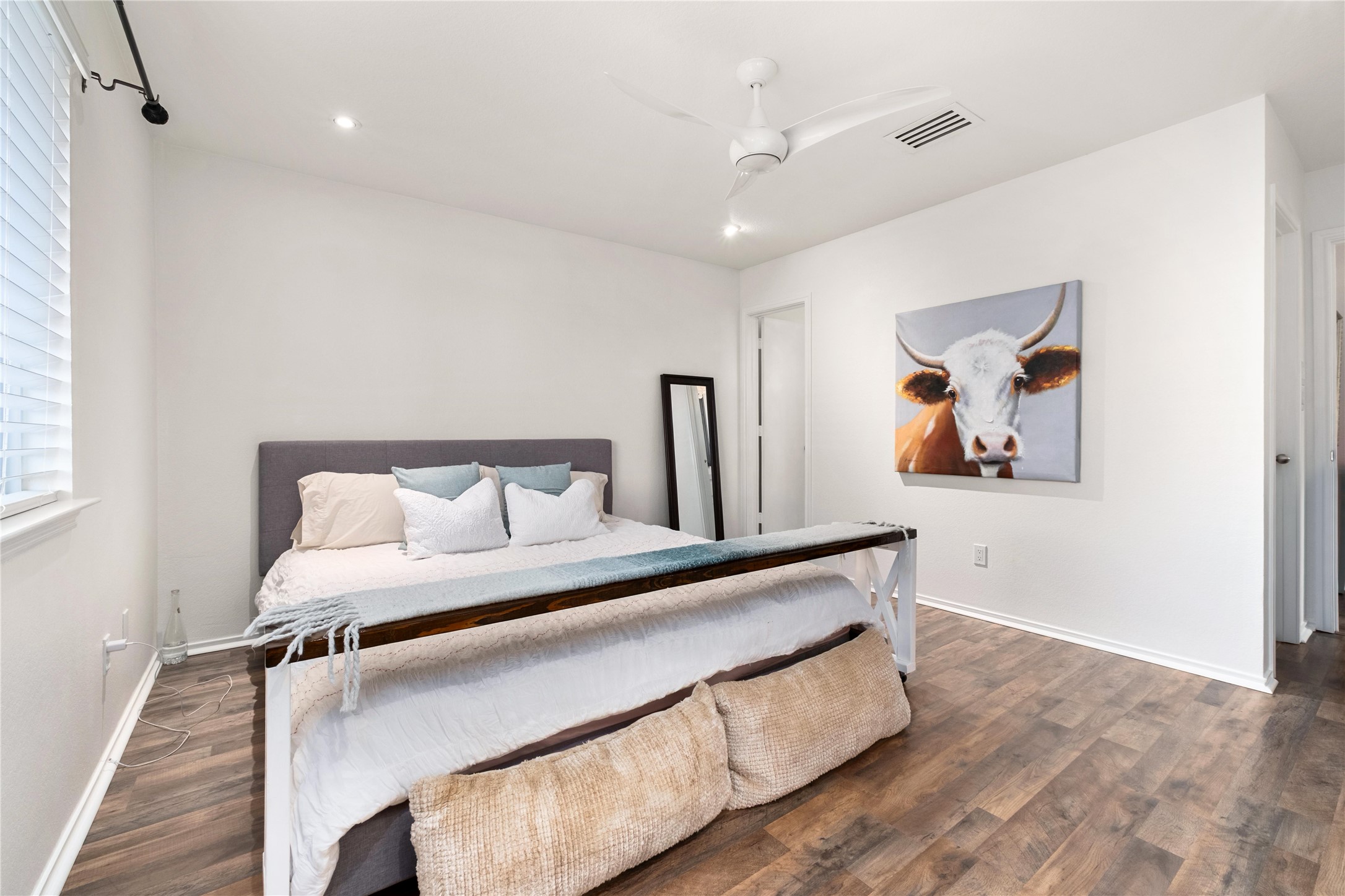 102 Woodley Road Leander, TX 78641 - Photo 9 of 24 a bed room with a bed and painting on the wall