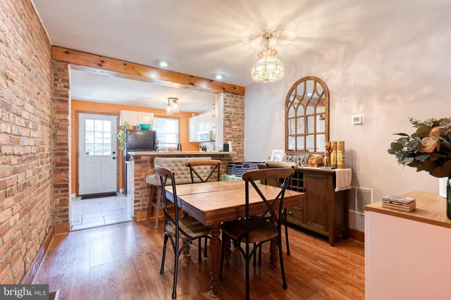 a view of a a dining room with furniture window and wooden floor