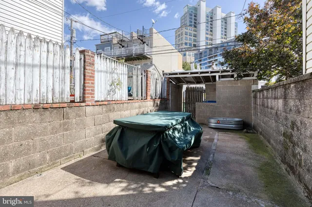 a view of a patio with table and chairs and potted plants