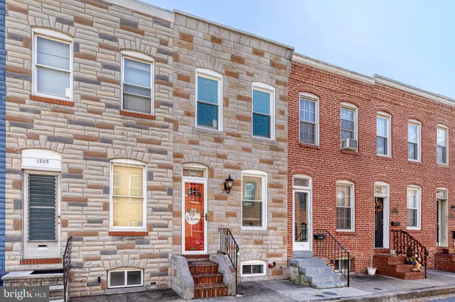 a front view of a building with many windows