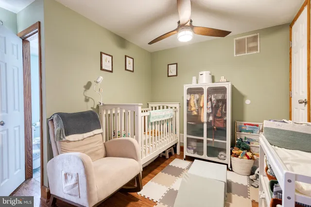 a bedroom with furniture and wooden floor