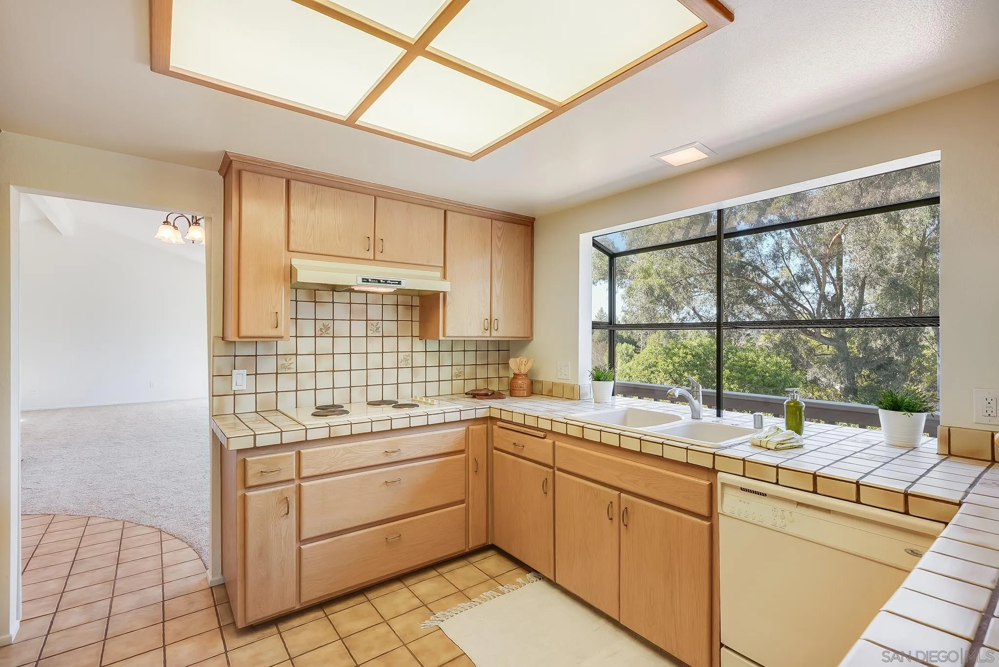 16456 Martincoit Road Poway, CA 92064 - Photo 19 of 55 a kitchen with a sink window and cabinets