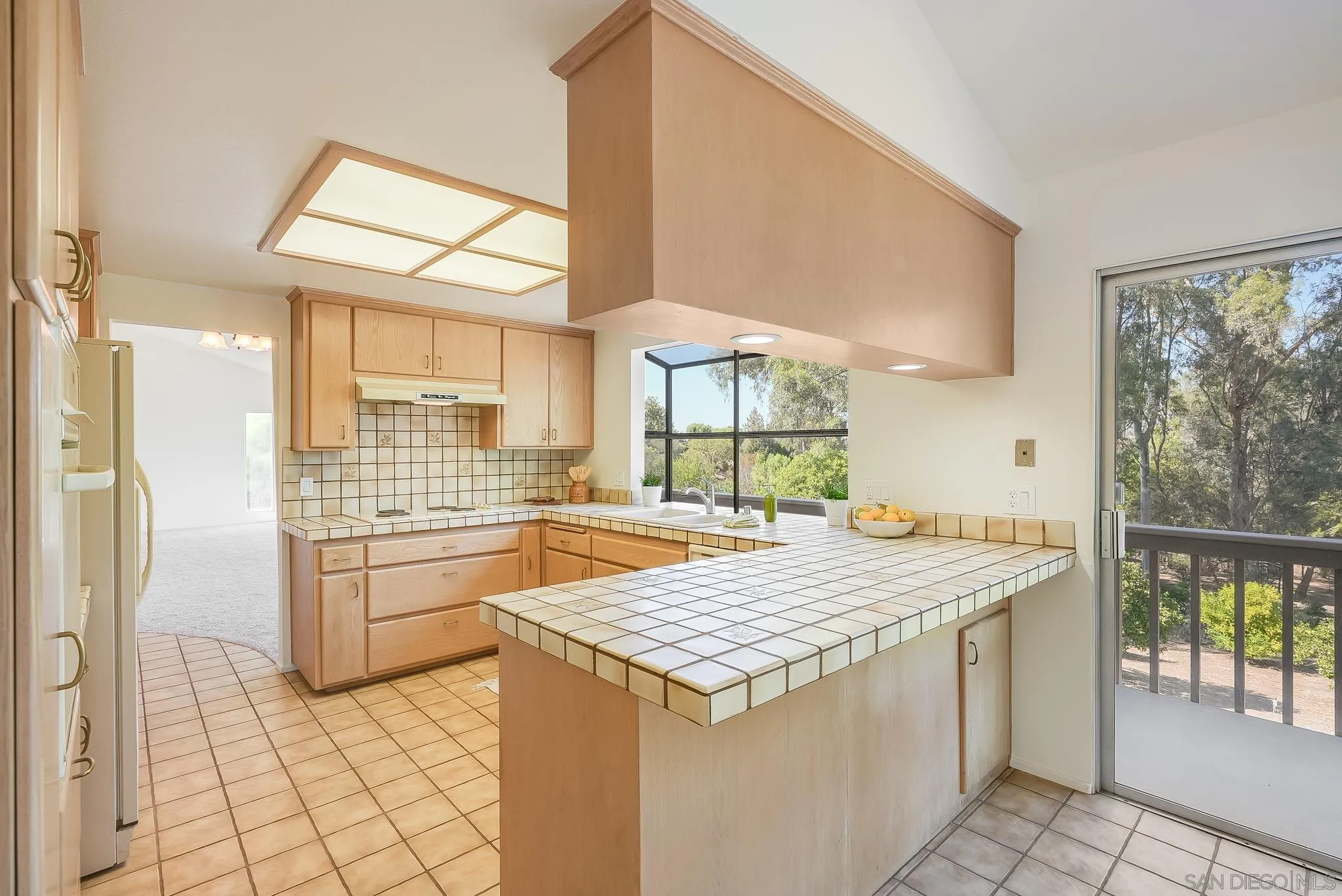 16456 Martincoit Road Poway, CA 92064 - Photo 22 of 55 a kitchen with granite countertop a refrigerator and a stove