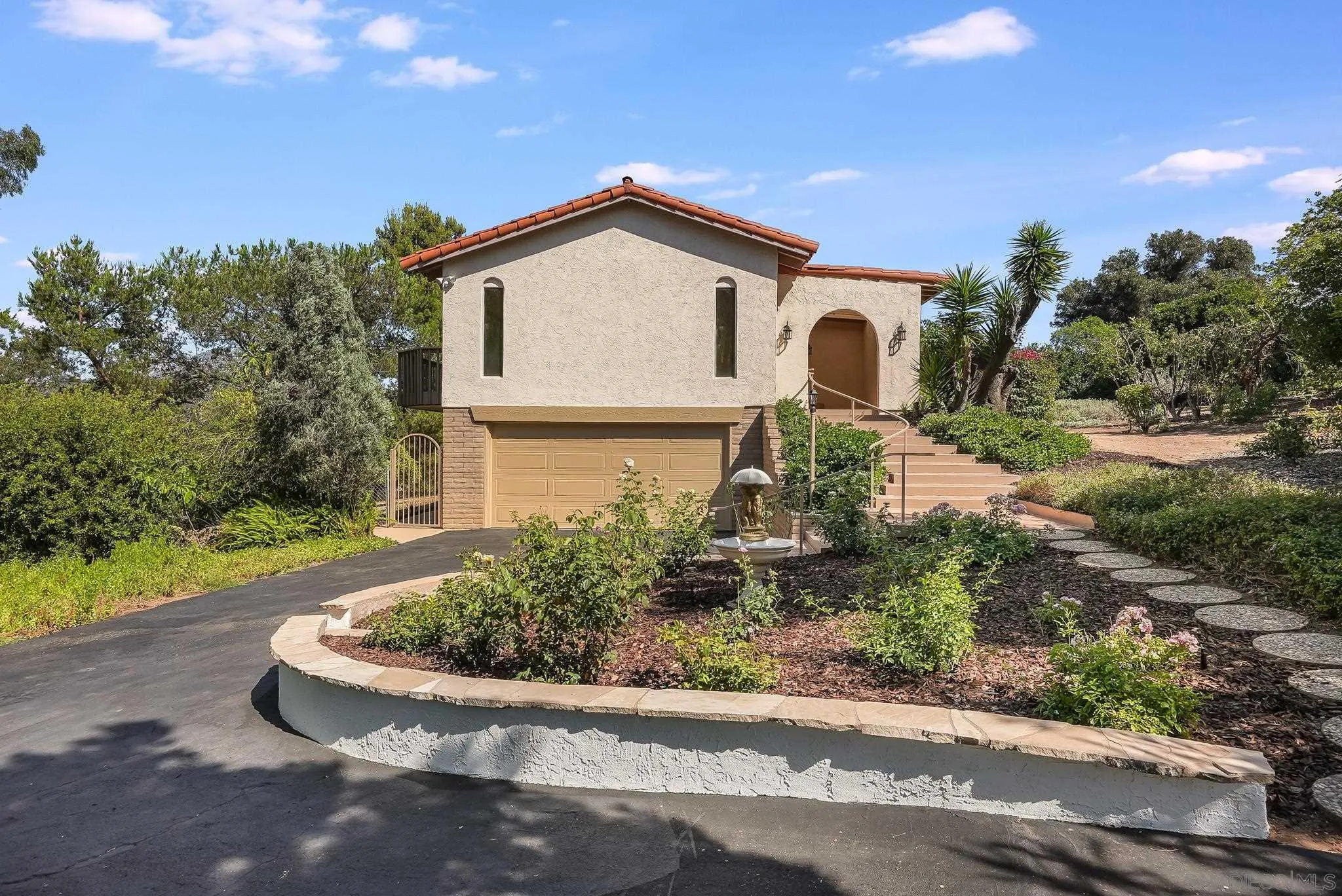 16456 Martincoit Road Poway, CA 92064 - Photo 3 of 55 a front view of a house with garden