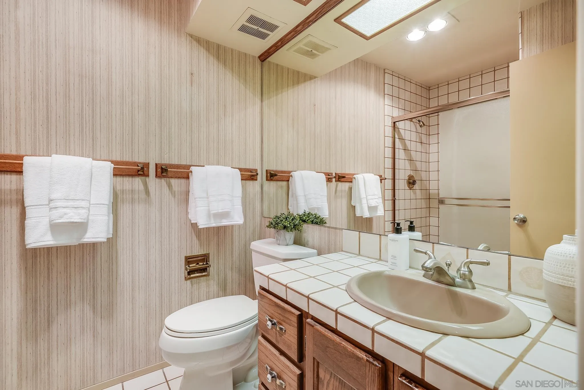 16456 Martincoit Road Poway, CA 92064 - Photo 33 of 55 a bathroom with a granite countertop sink and a mirror