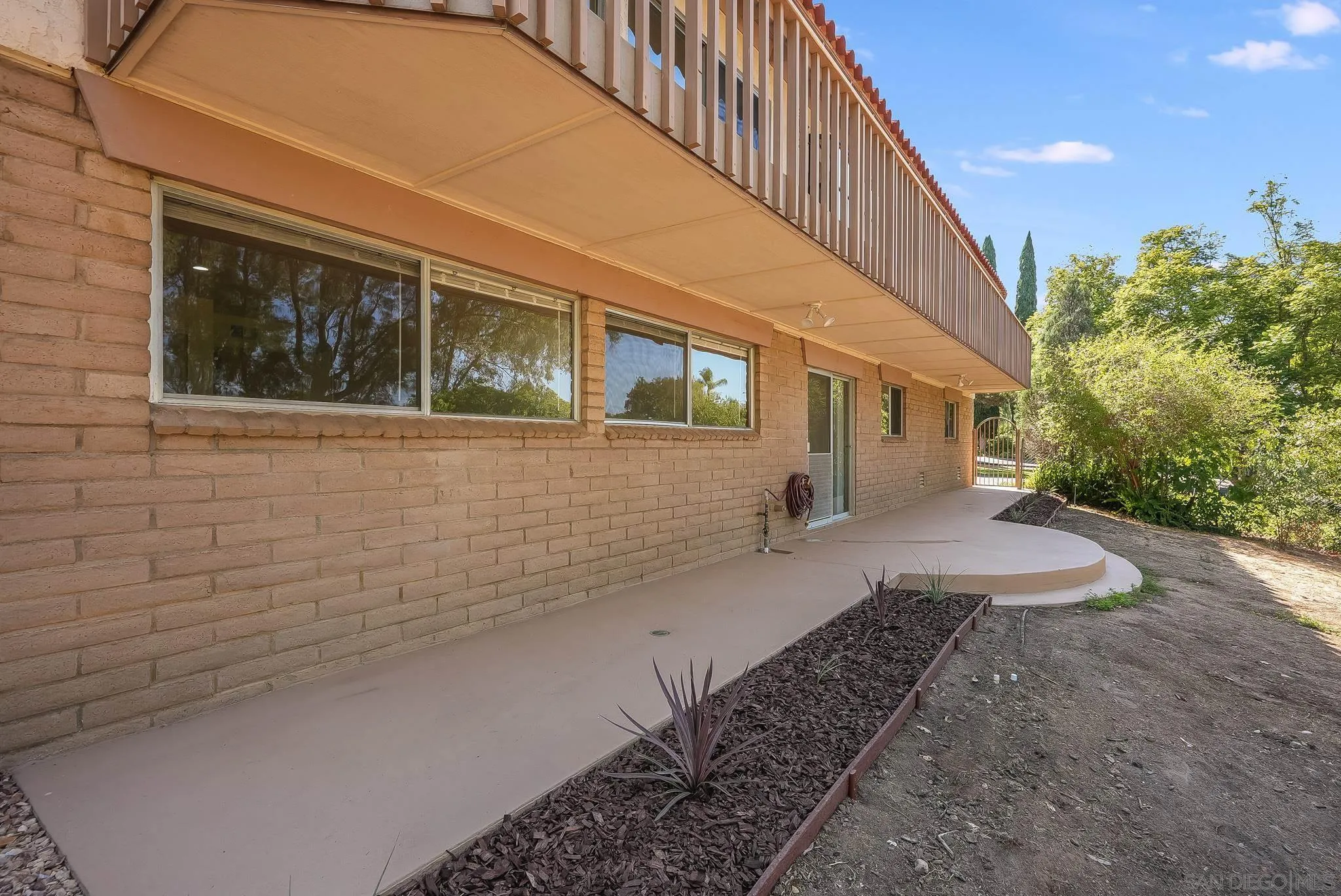 16456 Martincoit Road Poway, CA 92064 - Photo 8 of 55 a view of a house with backyard and trees
