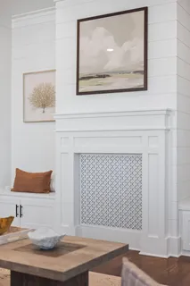 a room with a wooden floor and wall painting