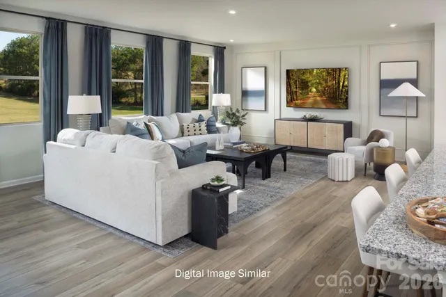 a living room with furniture and large window