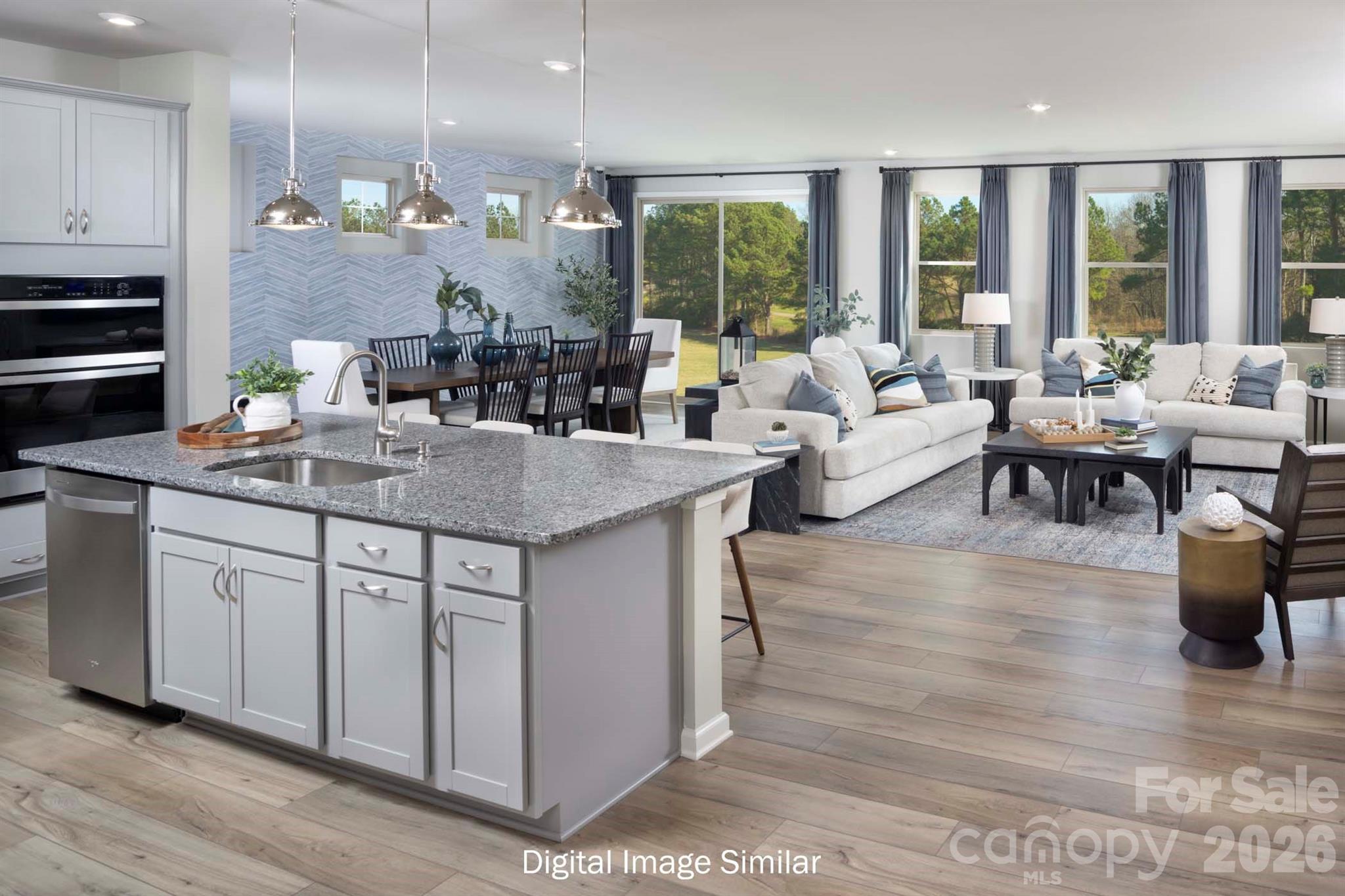 2550 Mabel Lane Monroe, NC 28110 - Photo 20 of 25 a kitchen with center island appliances and living room view