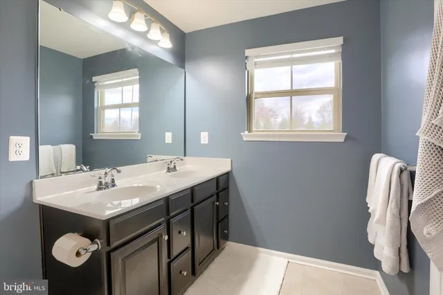 a bathroom with a sink mirror vanity and toilet