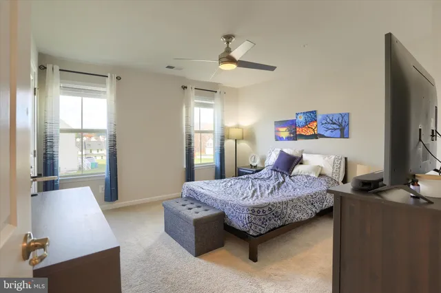a living room with a furniture and a flat screen tv