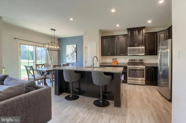 a kitchen with granite countertop counter space a sink appliances and cabinets