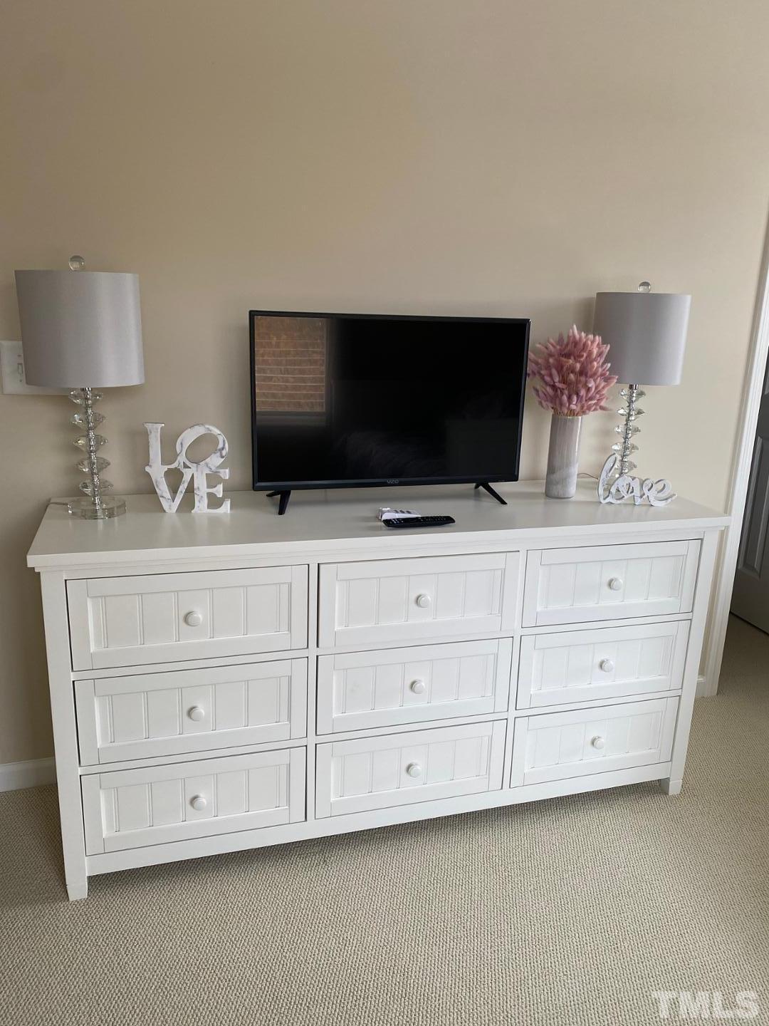 6006 McDevon Drive Raleigh, NC 27617 - Photo 10 of 12 a living room with cabinets and flat screen tv