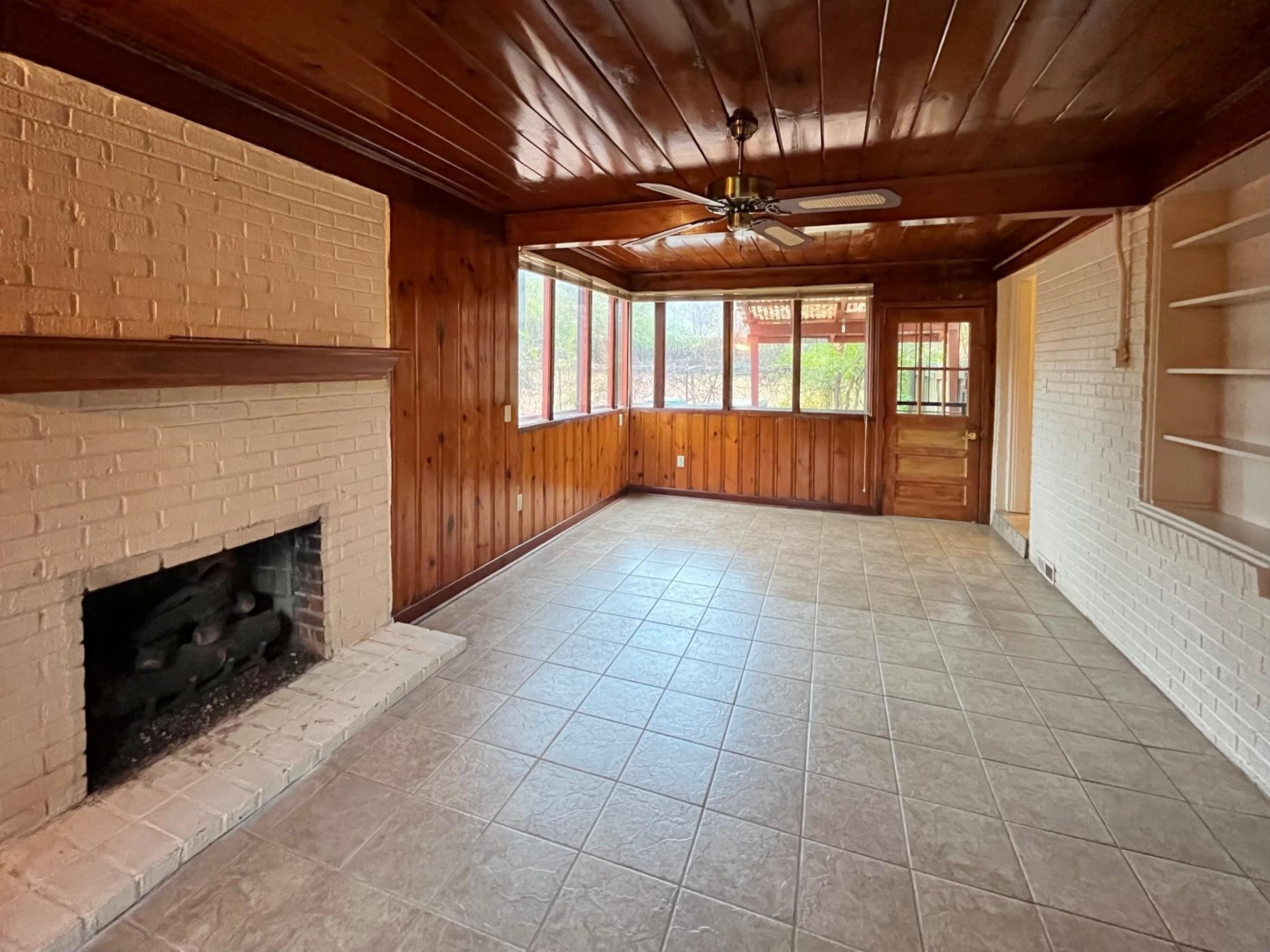 996 Tatum Road Memphis, TN 38122 - Photo 8 of 20 a view of an empty room with a fireplace and a window