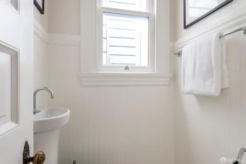 a bathroom with a granite countertop sink a mirror and a shower