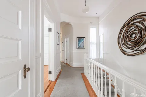 a view of staircase with wooden floor and a potted plant
