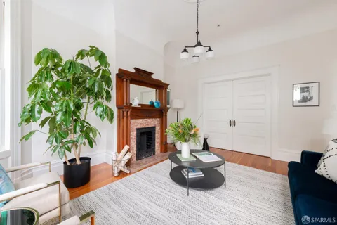a living room with furniture fireplace and potted plant