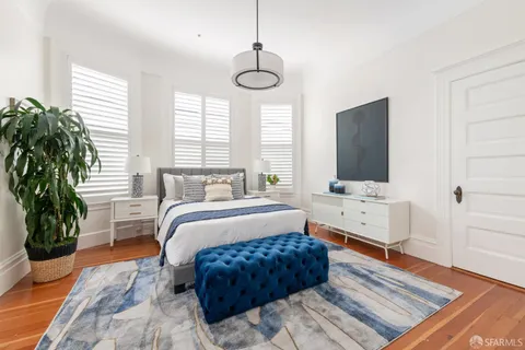 a bedroom with a bed and a potted plant