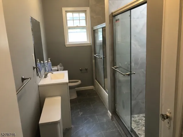 a bathroom with a toilet a sink and shower