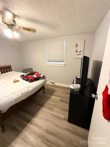 a bedroom with a bed and a table