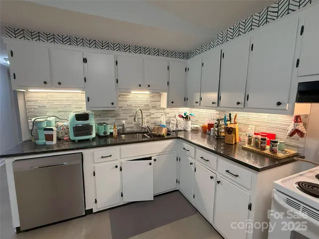 a kitchen with cabinets and window