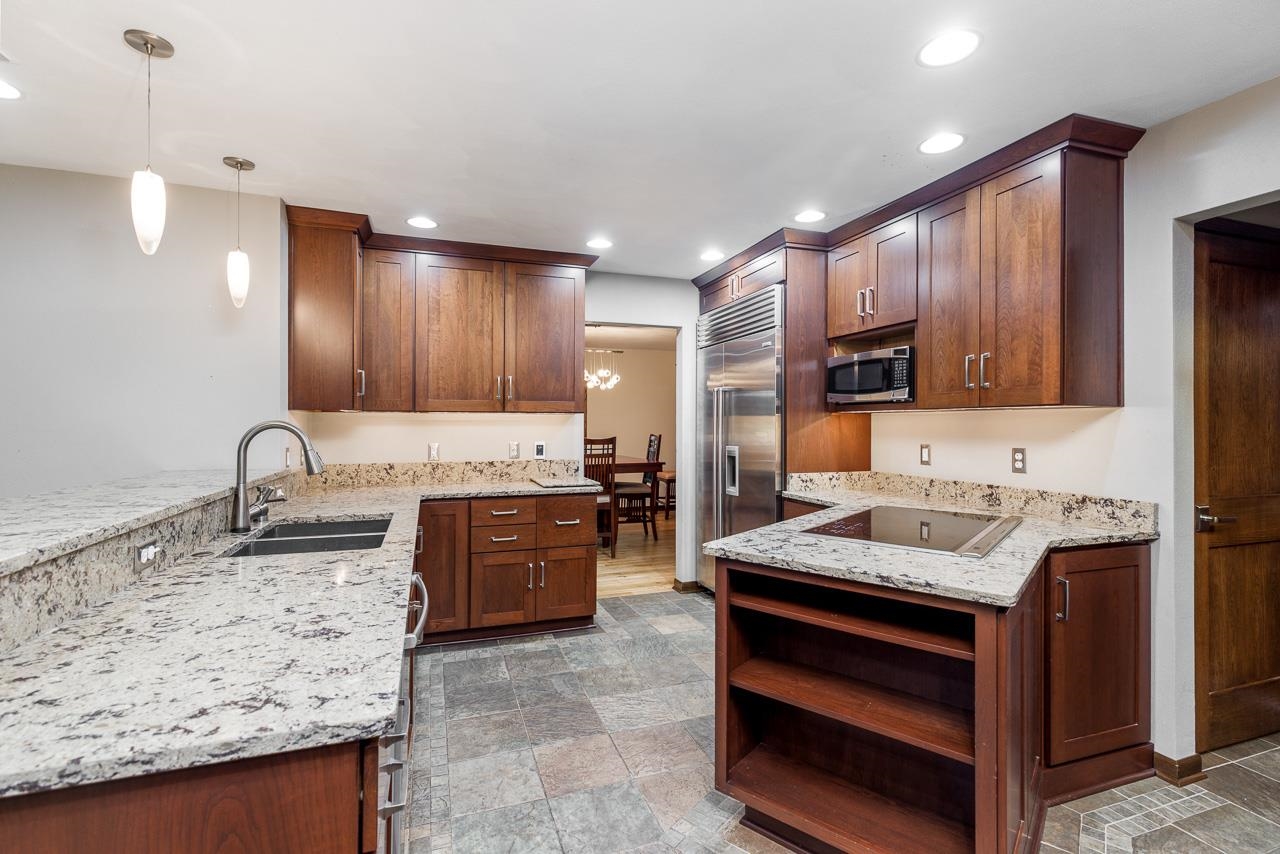 10694 Saddle Path Road Belvidere, IL 61008 - Photo 12 of 49 a kitchen with stainless steel appliances kitchen island granite countertop a sink stove and refrigerator