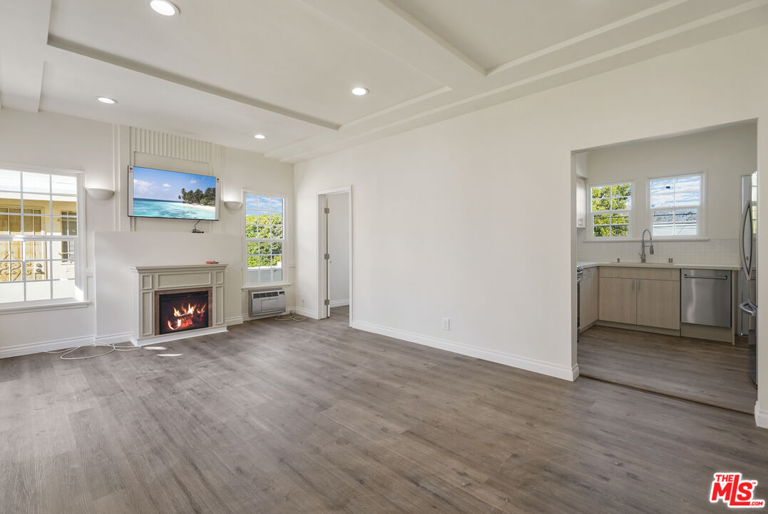 228 South Reeves Drive, Unit D Beverly Hills, CA 90212 - Photo 4 of 13 a view of a livingroom with a fireplace a fireplace and wooden floor