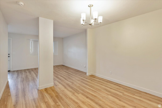38 South 1000th Street East Payson, UT 84651 - Photo 8 of 19 Spacious room featuring wood-finish flooring, white baseboards, and a contemporary ceiling light fixture