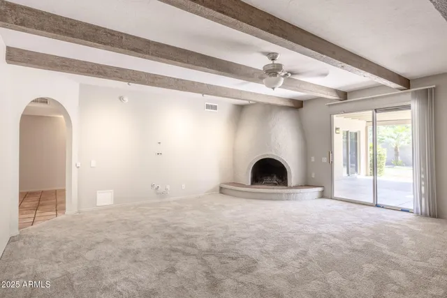 a view of a livingroom with a fireplace and window